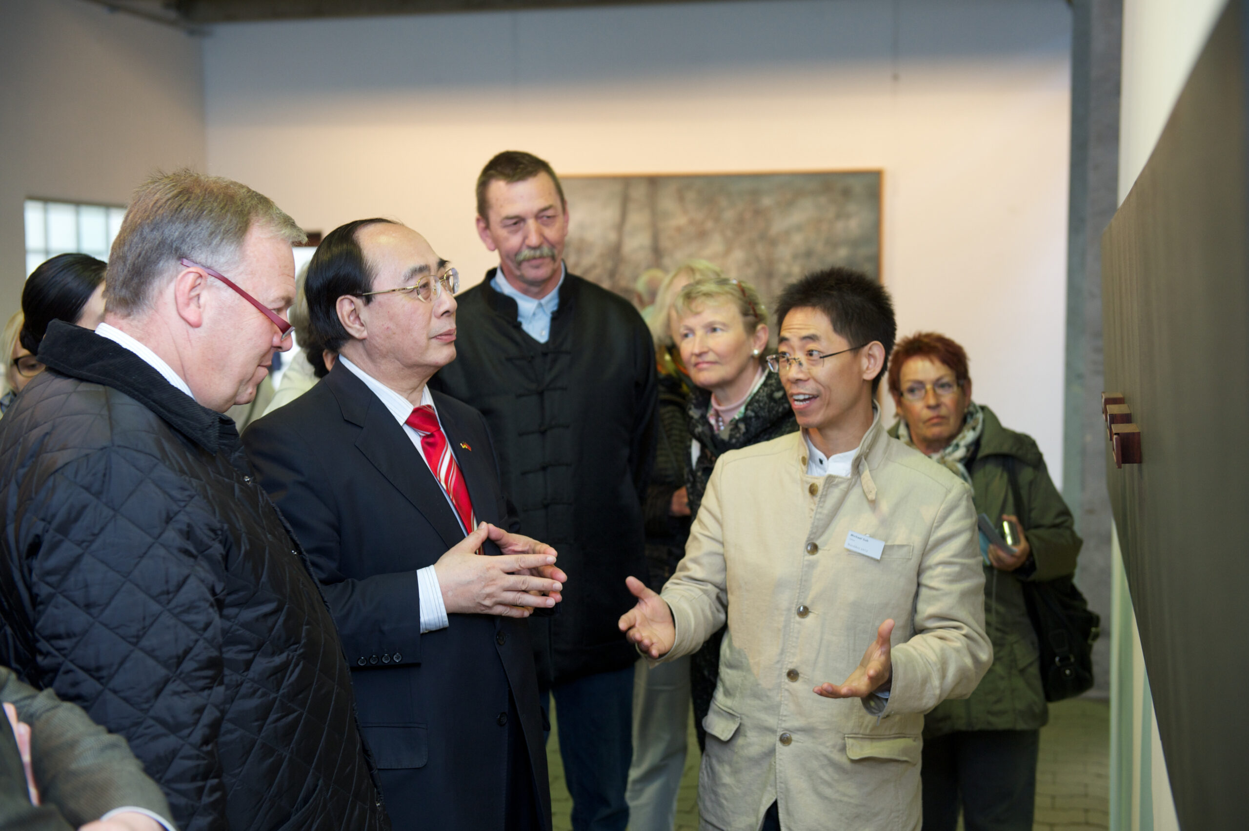 A curator introducing artwork to visitors at an exhibition in Germany in 2012.